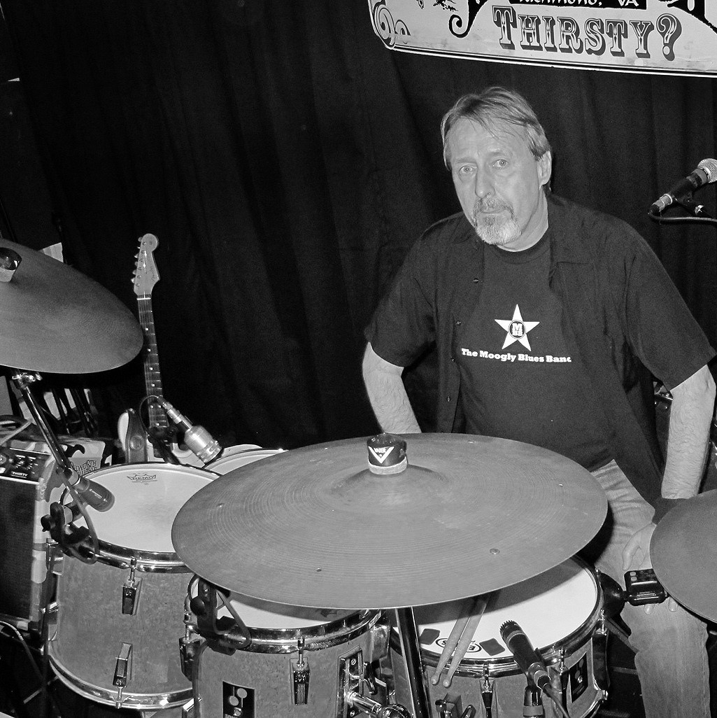 Image of researcher
                    Rainer Lindquist seated at drumset